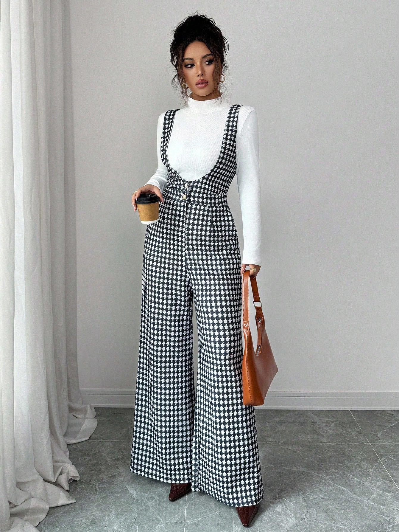 Elevate your fall wardrobe with this chic houndstooth jumpsuit set that screams effortless sophistication. The classic wide-leg silhouette pairs perfectly with a cozy turtleneck for those crisp autumn days when you want to look put-together without trying too hard. The timeless houndstooth pattern adds a playful twist to your everyday style, making it ideal for everything from casual outings to weekend brunches. Comfortable, versatile, and undeniably stylish—this is the one-piece wonder that'll become your 