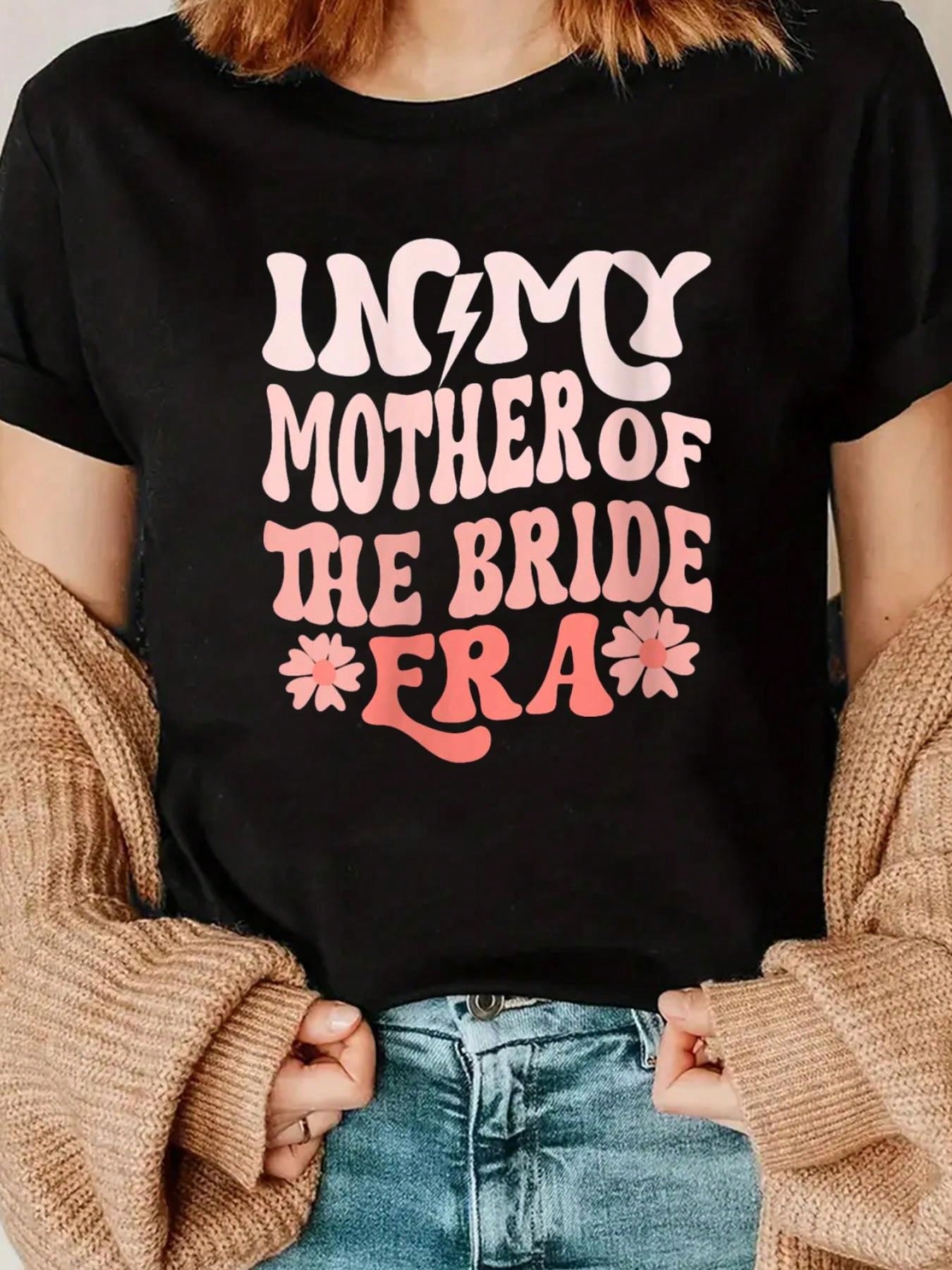 Embrace your motherly charm with our Chic 'In My Mother of the Bride Era' V-Neck T-Shirt. Perfect for proud moms, this shirt celebrates your special role in your daughter's wedding day. Comfortable and stylish, it's a must-have for any mother of the bride!