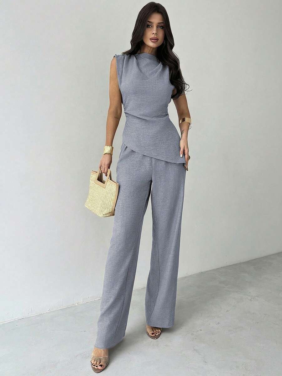 Elevate your workweek with this sophisticated khaki 2-piece set designed for the modern professional. The asymmetric sleeveless blouse pairs seamlessly with wide-leg pants, creating an effortlessly chic silhouette perfect for office days, casual commutes, and weekend getaways. Crafted from 100% polyester woven fabric, this set offers a polished, minimalist aesthetic with a comfortable loose fit. 