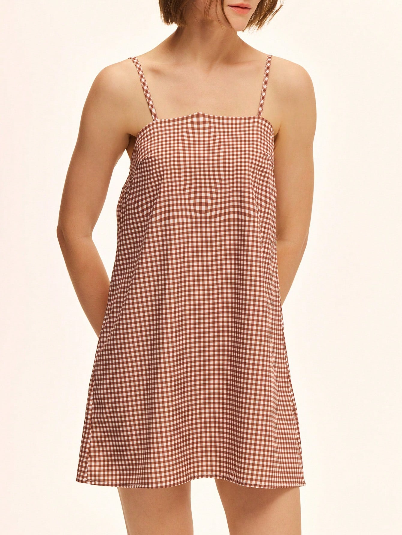 Step out in playful charm with this chic khaki and white plaid casual strap dress. Its light, breezy fabric and flattering cut make it perfect for everything from brunch dates to weekend adventures. Easy to dress up or down, this dress brings effortless style and a touch of fun to your wardrobe.