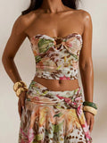 Front studio view of multicolor tropical print mesh bandeau crop top and flowing high-slit maxi skirt two-piece set for beach vacation styling