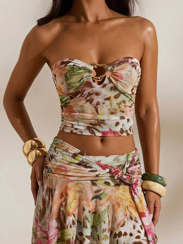 Front studio view of multicolor tropical print mesh bandeau crop top and flowing high-slit maxi skirt two-piece set for beach vacation styling