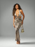 Unleash your inner wildcat and turn heads at any evening party with this chic Leopard Cutout Halter Maxi Dress! The playful cutouts and halter neckline add a touch of sass, while the floor-length gown creates an elegant and flattering silhouette. Get ready to roar with this fierce and fun dress!