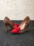 Elevate your evening look with these stunning chic stiletto pumps. Adorned with a playful leopard print bow, these pumps add a touch of flair to the classic color block design. Perfect for making a statement and turning heads, these pumps are a must-have for any fashion forward individual.