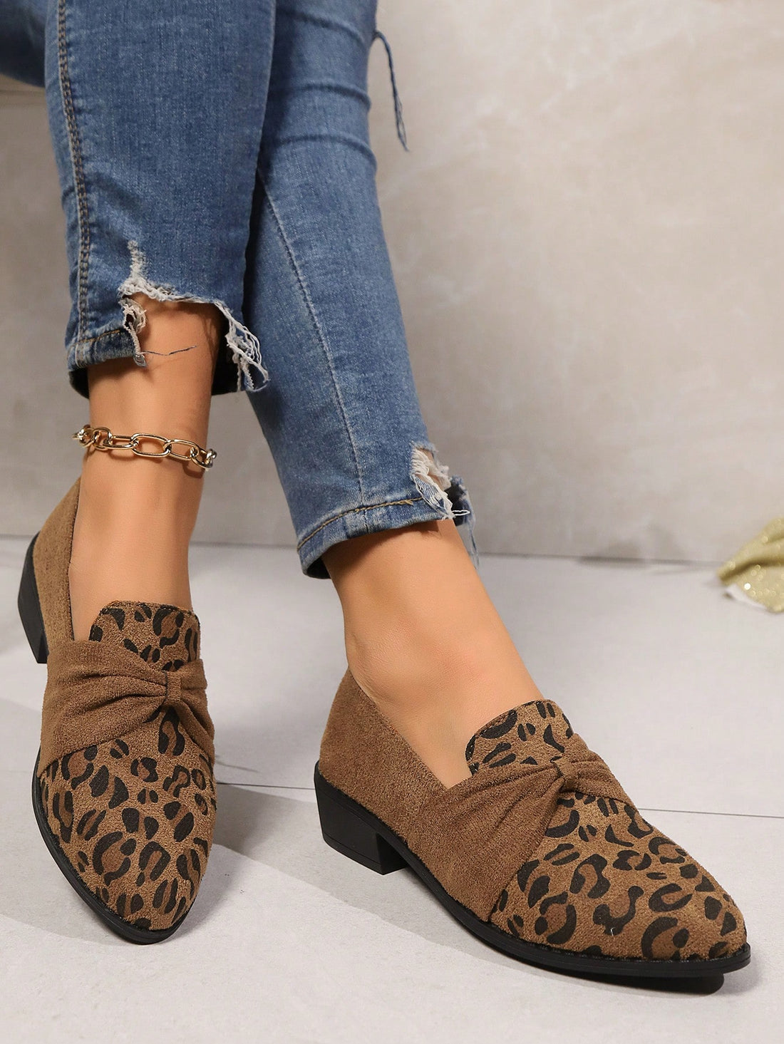 Step into effortless style with these leopard print slip-on flats that blend wild sophistication with everyday comfort. The charming bow detail and pointed toe silhouette add a touch of playful elegance to any outfit, while the slip-on design keeps you moving through your day without missing a beat. Perfect for commuting, casual outings, or whenever you want to look put-together without the fuss. These versatile flats transition seamlessly across seasons, making them the go-to shoe that works as hard as you