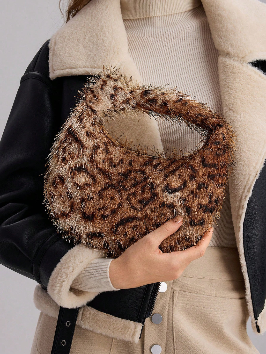 Upgrade your fashion game with our Chic Leopard Print Faux Fur Puffy Handbag. Featuring soft, luxurious faux fur, this handbag is a statement piece that will elevate any outfit. Stay stylish and on-trend with our bold leopard print design.