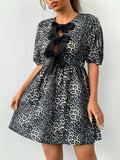 This chic dress features a trendy leopard print and unique half-sleeve design. The bow tie detail adds a touch of femininity, making it the perfect statement piece for any occasion. Elevate your style and feel confident with this dress that combines fashion and functionality.