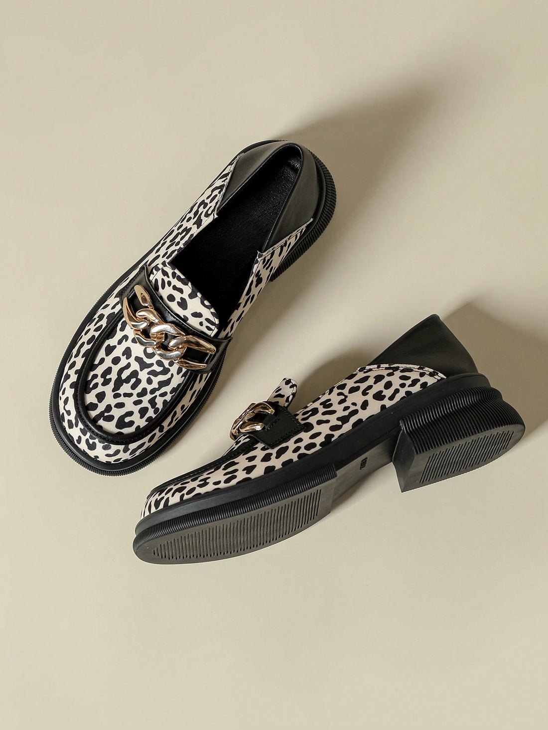 Elevate your shoe game with these chic leopard print mid-chunky heel loafers. Featuring a stylish metal buckle, these loafers add a touch of sophistication to any outfit. With a comfortable mid-height heel, you can rock these all day without sacrificing style. Step out with confidence in these trendy loafers.