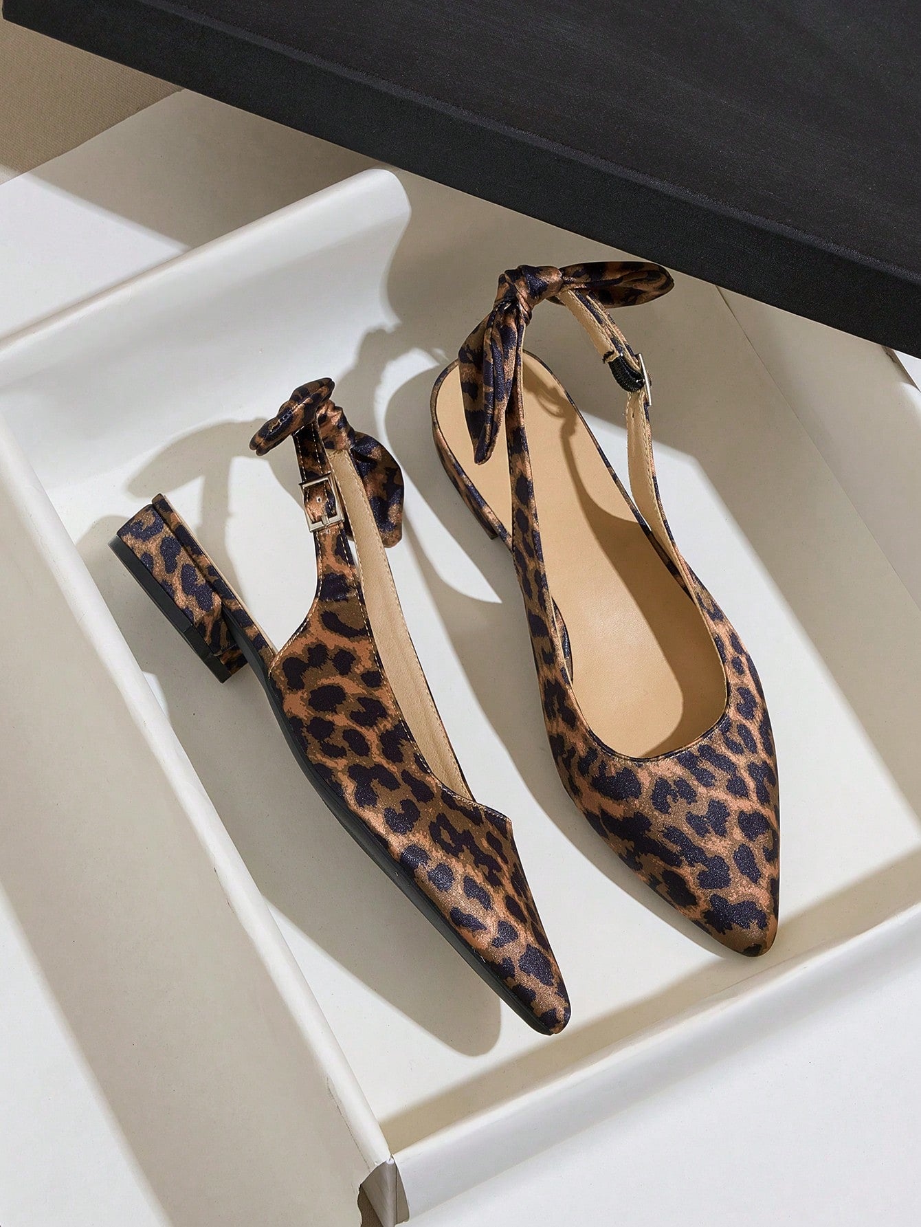 Add a fierce touch to your footwear collection with these Chic Leopard Print Open Back High Heel Sandals. Featuring a playful fashion bow and chunky heels, these sandals are a perfect blend of style and comfort. Step out in style and turn heads with these bold and fashionable sandals.
