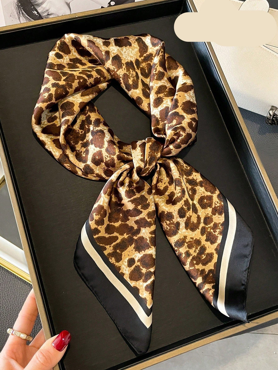 Add a touch of elegance to any outfit with our Chic Leopard Print Silk Square Scarf. Crafted from high-quality silk, this versatile accessory is perfect for stylish women looking to elevate their fashion game. The on-trend leopard print pattern adds a bold statement to any look, making it a must-have for any wardrobe.