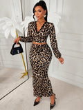 Turn heads in this stunning leopard print two-piece set that effortlessly blends sophistication with sass. The elegant deep V-neck top flatters your silhouette while the high-slit skirt adds a flirty touch of allure. Perfect for date nights, brunch with friends, or whenever you want to feel absolutely fabulous. This versatile set transitions seamlessly from day to evening, making it a must-have addition to your wardrobe. Embrace your wild side with timeless leopard print style.