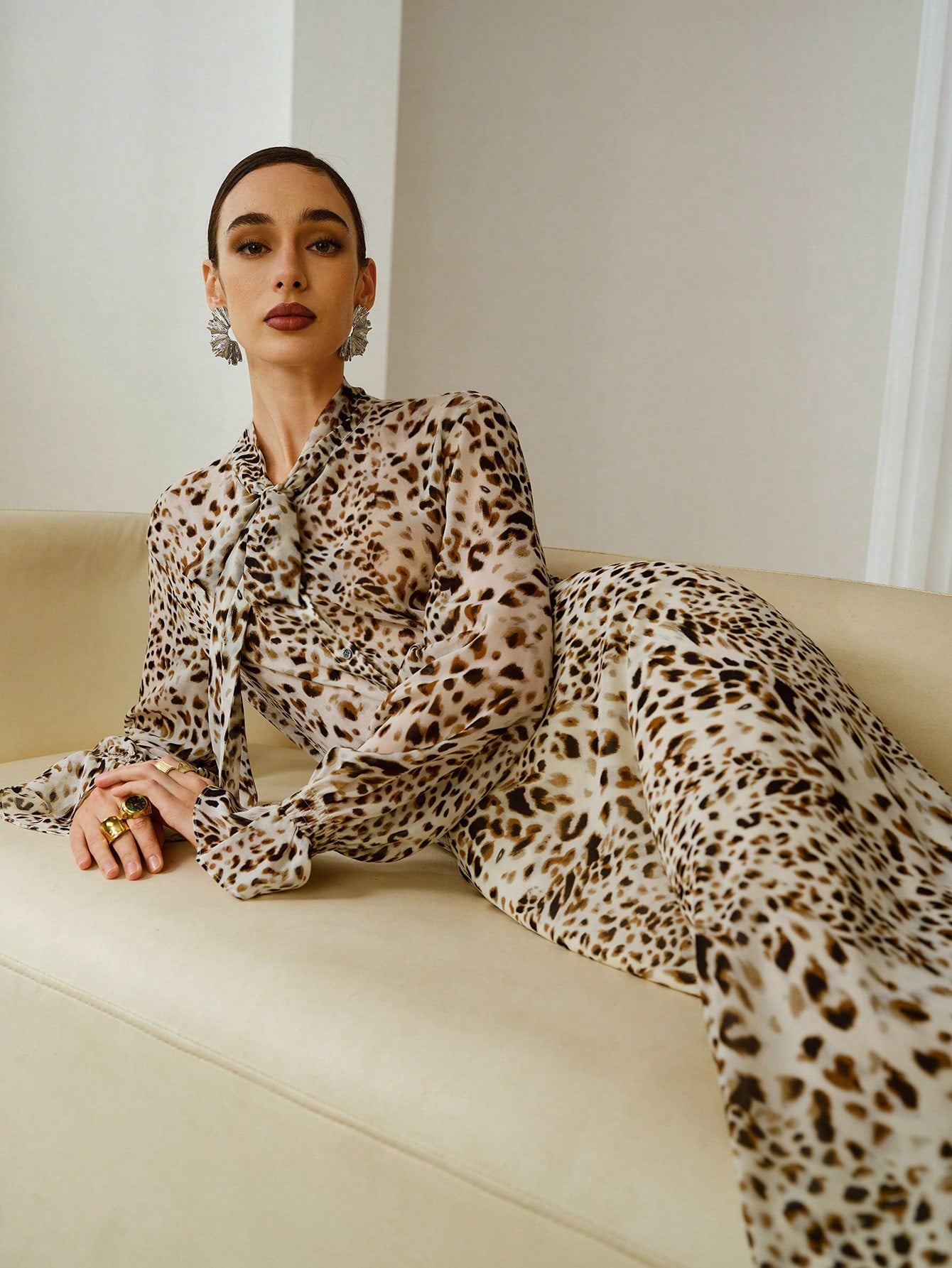 Unleash your wild side this season with our stunning leopard print two-piece set! The cropped tie-waist shirt cinches perfectly at the middle for a flattering silhouette, while the fishtail hem skirt adds a flirty, fashion-forward finish. This dynamic duo transitions seamlessly from casual day looks to evening vibes, making it your go-to autumn and winter statement piece. Pair it with your favorite boots or sneakers to complete the look. Bold, versatile, and undeniably chic—because sometimes you've gotta ro