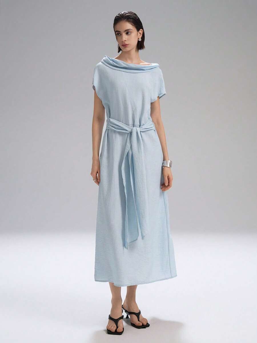 Step into effortless charm with this chic light blue long dress, featuring playful cap sleeves and a stylish draped neck. Perfect for vacation strolls or countryside escapes, it combines comfort and elegance to keep you feeling fabulous wherever you go.