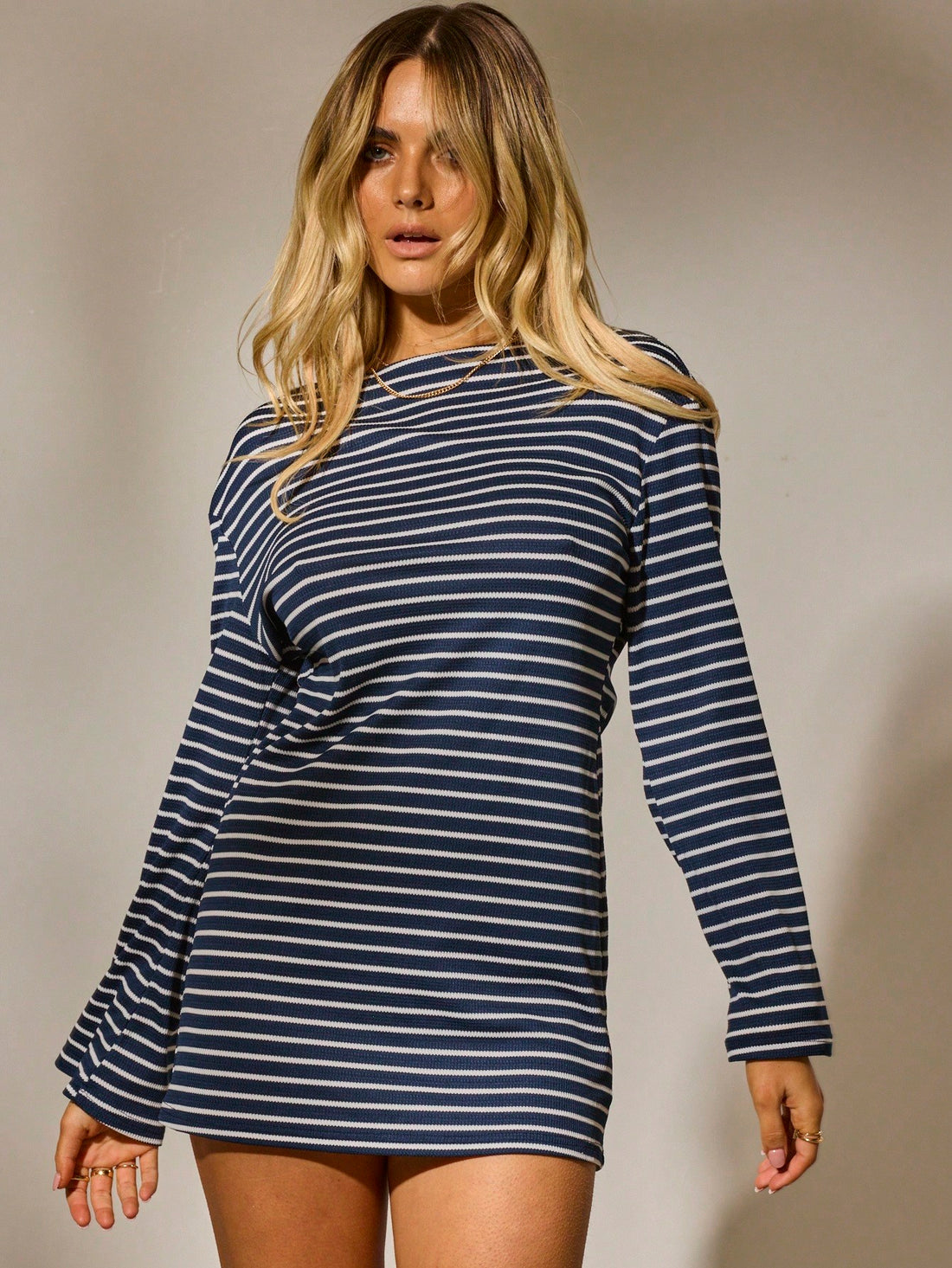 Turn heads with this chic long sleeve mini dress featuring a flirty cut-out back. Perfectly tailored for effortless style, it’s your go-to for unforgettable date nights or breezy vacation days. Lightweight and playful, it moves with you while adding a dash of daring charm to your look.