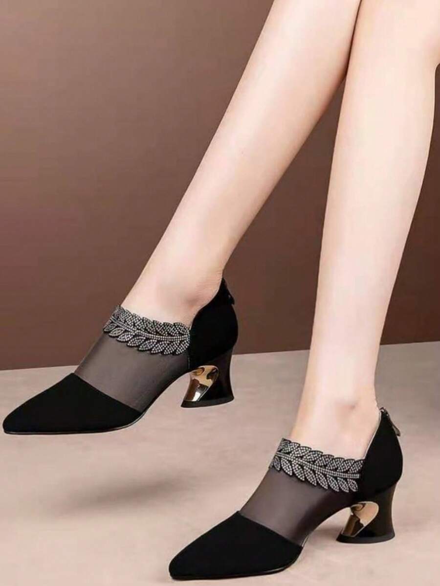 Front view of black pointed toe mesh dress pumps with rhinestone leaf trim