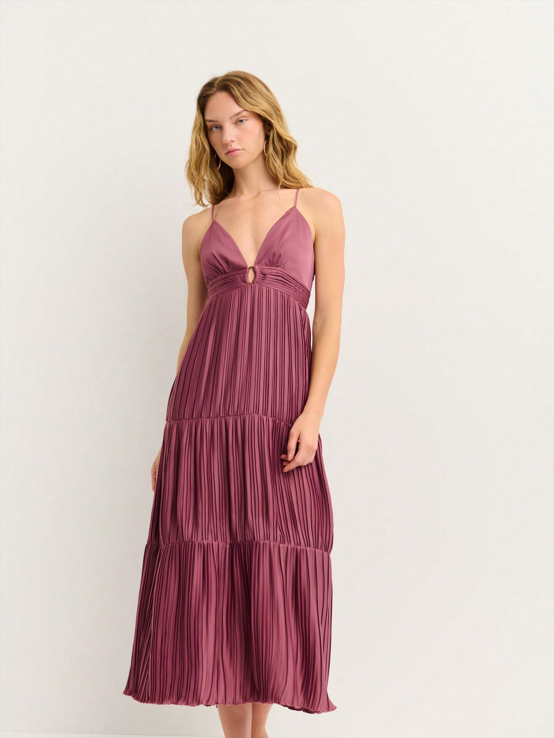 Turn heads at your next summer celebration in this effortlessly chic midi dress. The flattering V-neckline draws attention upward while the strappy back detail adds an unexpected twist of allure. Crafted from lightweight fabric, it's breathable enough for all-day wear at festivals and parties without sacrificing style. Whether you're dancing under the stars or sipping cocktails with friends, this versatile piece transitions seamlessly from day to night. The midi length offers just the right amount of covera