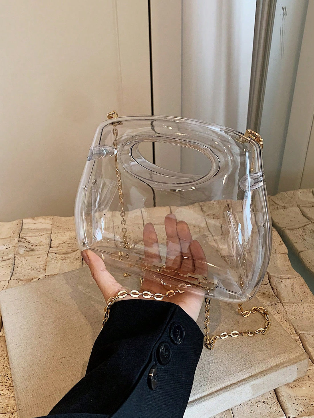 Introducing the Chic Mini Acrylic Box Bag - the perfect accessory for the trendsetting woman. This transparent bag fits perfectly under your arm, adding a touch of style to any outfit. Its compact size allows you to easily carry all your necessities while still making a statement. Stand out with this unique shoulder bag today!