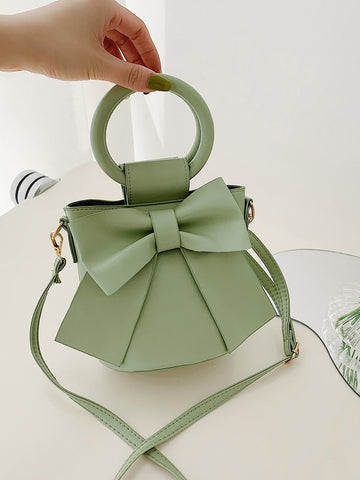 Introducing the Chic Mini Bow Decor Top Ring Bucket Bag, the perfect addition to your wardrobe for any occasion. With its elegant top ring design and chic bow decor, this bag is both stylish and functional. Made with high-quality materials, it's the perfect accessory to elevate any outfit.