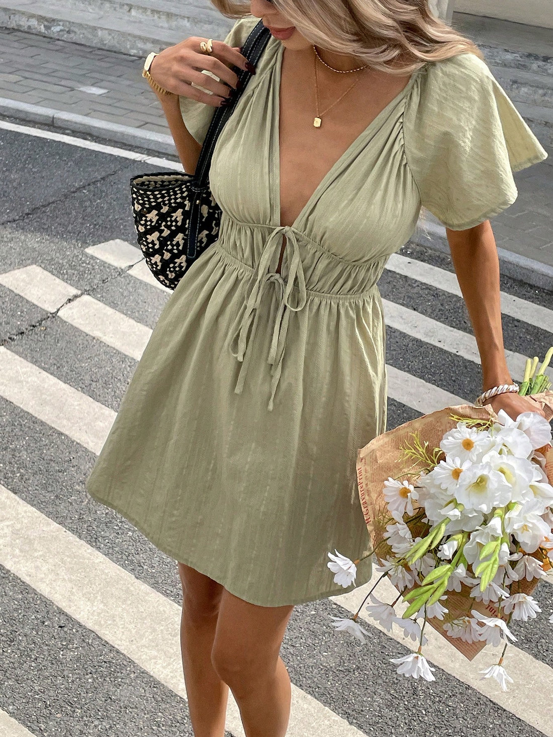 Flaunt your summer style in this flirty mini dress! The deep V-neck adds just the right amount of sass, while those adorable ruffle sleeves bring the fun. Perfect for beach days, rooftop parties, or anywhere you want to turn heads. This little number screams "summer confidence" with every twirl!