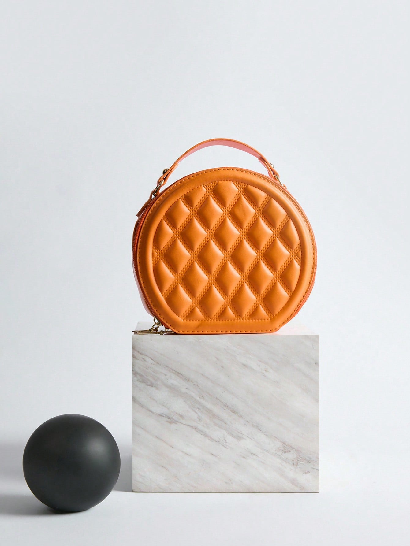 Add a dash of charm to your look with this Chic Mini Quilted Crossbody Bag. Its playful round shape and quilted texture blend style and fun, making it perfect for carrying your essentials hands-free. Whether out for errands or a night on the town, this compact handbag keeps you looking effortlessly cool and ready to go.