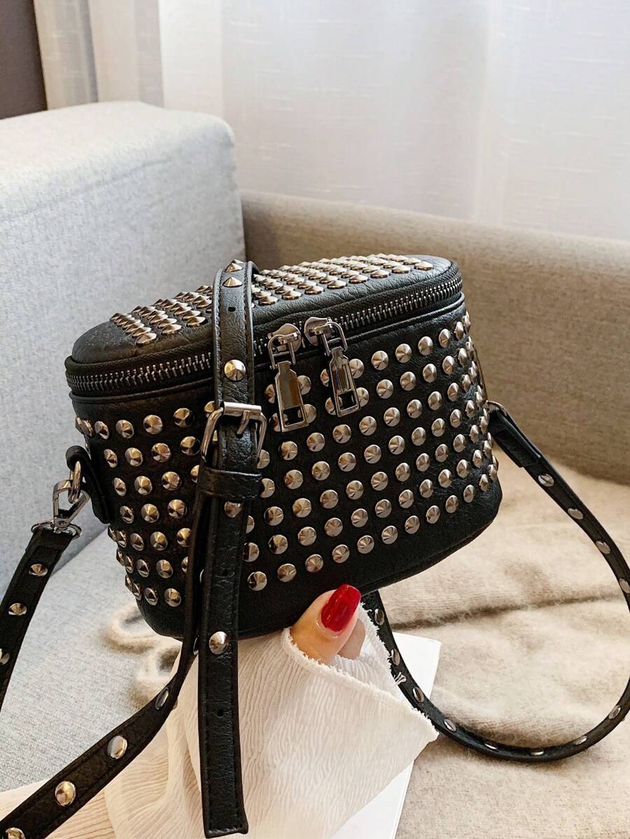 Make a statement with this edgy mini box bag that's all attitude and zero apologies. Featuring bold asymmetric styling and eye-catching studs, it's the perfect accessory for anyone ready to embrace their punk-rock side. The compact shoulder silhouette keeps things practical while the solid color base lets those metallic details steal the show. Whether you're heading to a night out or adding edge to your everyday look, this bag brings the cool factor without trying too hard.