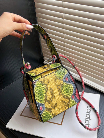 Add a touch of modern elegance to your wardrobe with our Chic Mini Yellow Snake Print Cube Handbag. Expertly crafted with stylish snake print and a unique cube shape, this handbag is perfect for any occasion. Stay trendy and organized with this versatile shoulder bag.