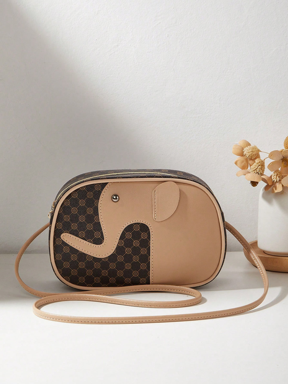 Go wild with fashion using our Chic Minimalist Faux Leather Elephant Print Crossbody Bag! With its unique elephant print and sleek, minimalist design, this bag is perfect for adding a playful touch to any casual or business style. Plus, its durable faux leather ensures long-lasting use. (You'll never forget how stylish you look carrying this bag!)