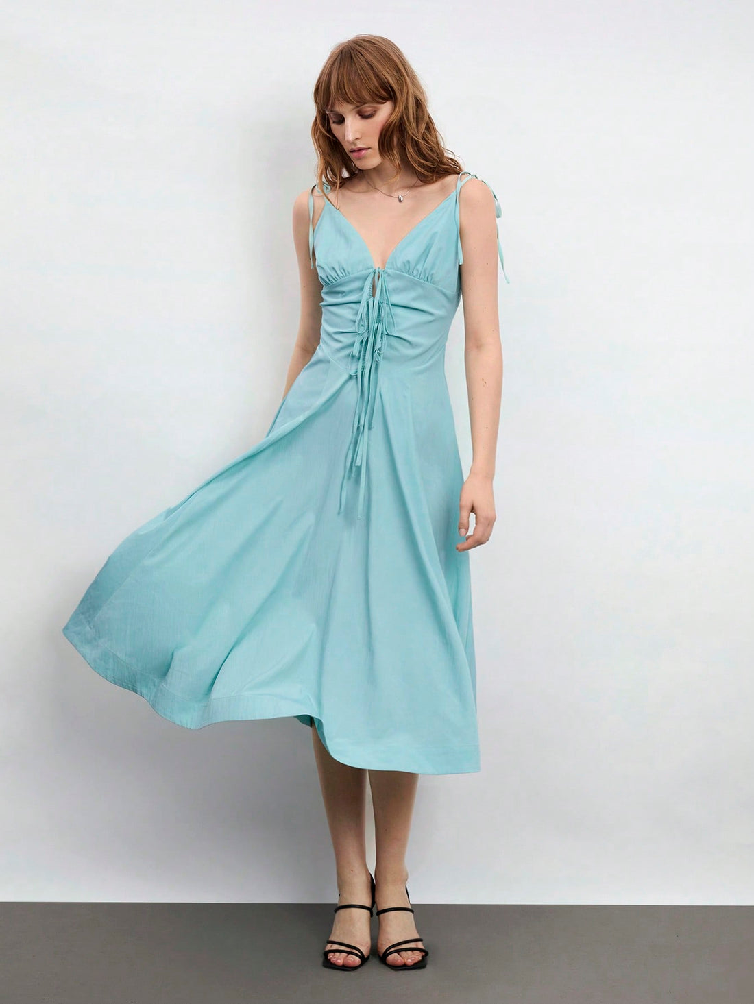 Elevate your warm-weather wardrobe with this charming mint green midi dress that's equal parts sophisticated and fun. The flattering V-neckline and delicate spaghetti straps create an effortlessly elegant silhouette, while the adorable bowknot detail adds a playful touch that'll have you feeling fabulous. Perfect for spring brunches, summer garden parties, or any occasion calling for a little extra polish. Slip it on and let the compliments flow!