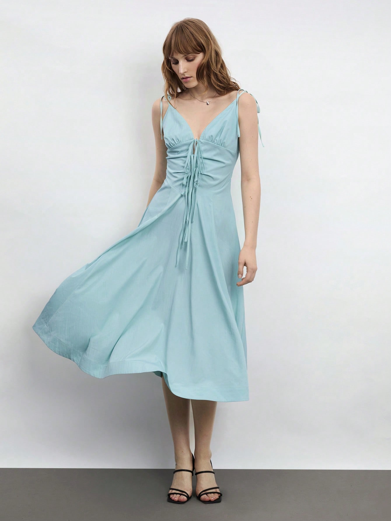 Elevate your warm-weather wardrobe with this charming mint green midi dress that's equal parts sophisticated and fun. The flattering V-neckline and delicate spaghetti straps create an effortlessly elegant silhouette, while the adorable bowknot detail adds a playful touch that'll have you feeling fabulous. Perfect for spring brunches, summer garden parties, or any occasion calling for a little extra polish. Slip it on and let the compliments flow!