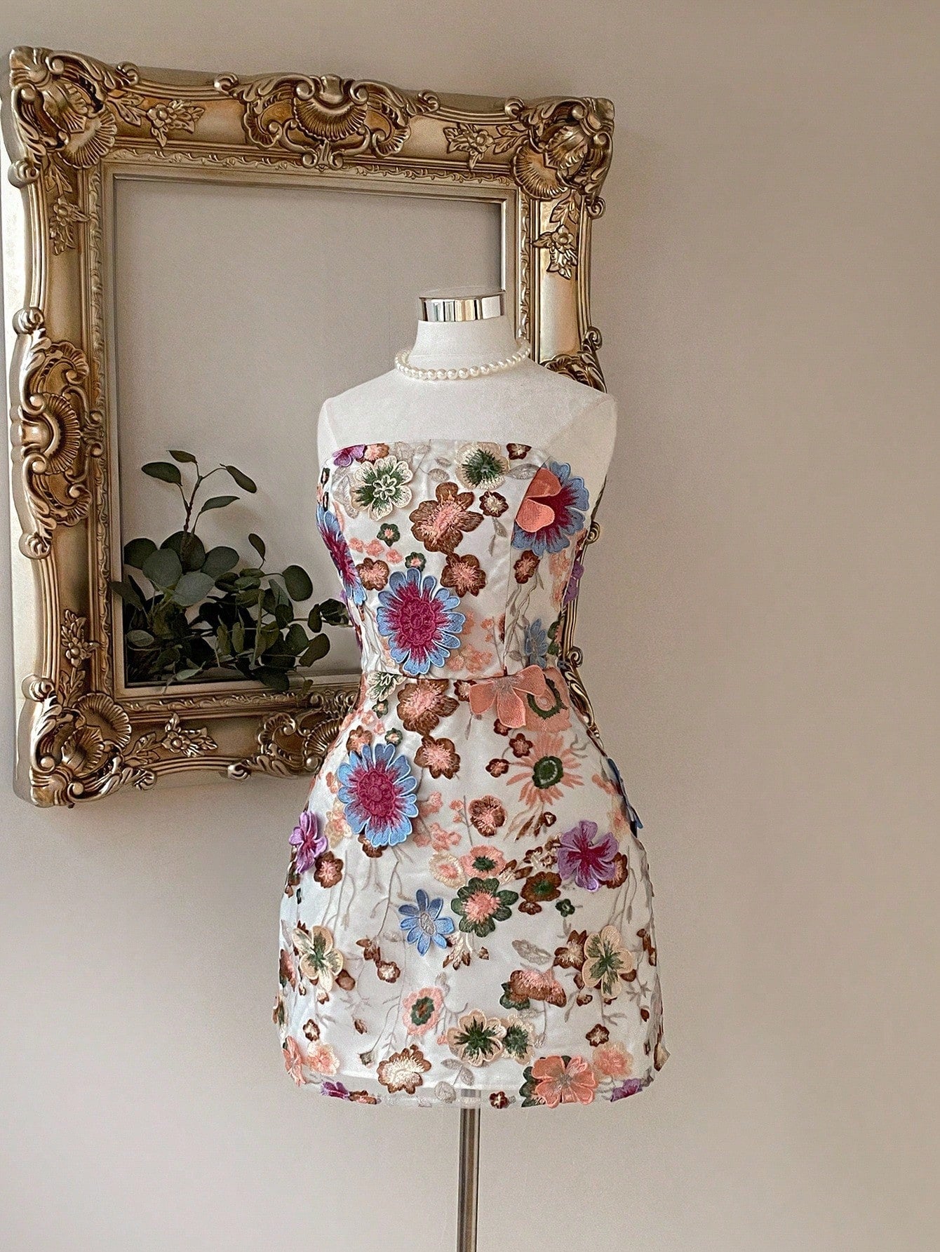 Step out in style with this playful mini dress featuring vibrant multi-color 3D mesh embroidery. Its adjustable criss-cross back lets you customize your fit, keeping you comfortable from day to night. Perfect for turning heads at any event, this dress combines fun design with effortless charm.