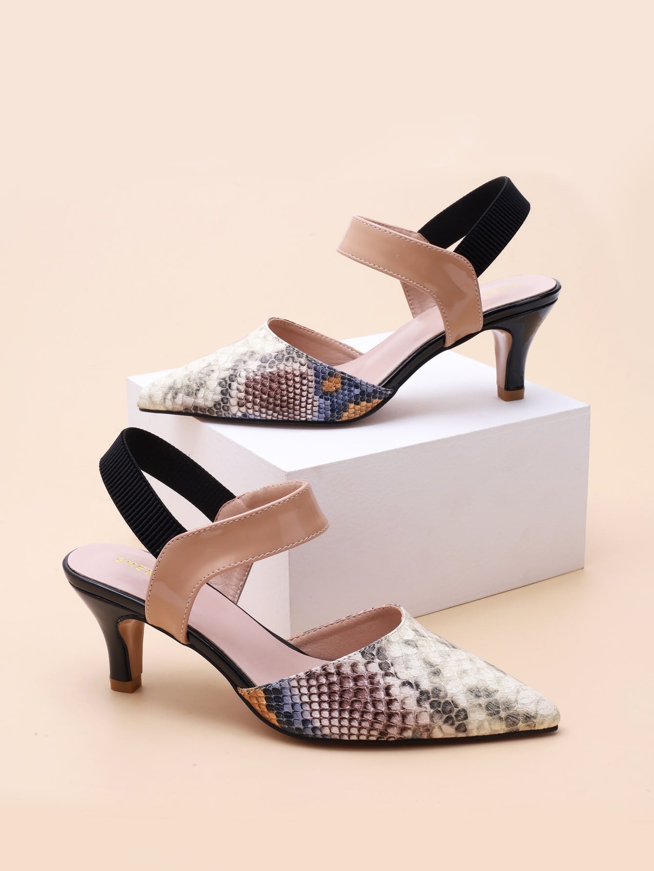 Step into style with these chic multi-color snakeskin slingback pumps for women. The stylish pointed toe and mid-high heels make them perfect for the spring and summer. Elevate any outfit and show off your playful side with these quirky and fun pumps. (Pun intended!)