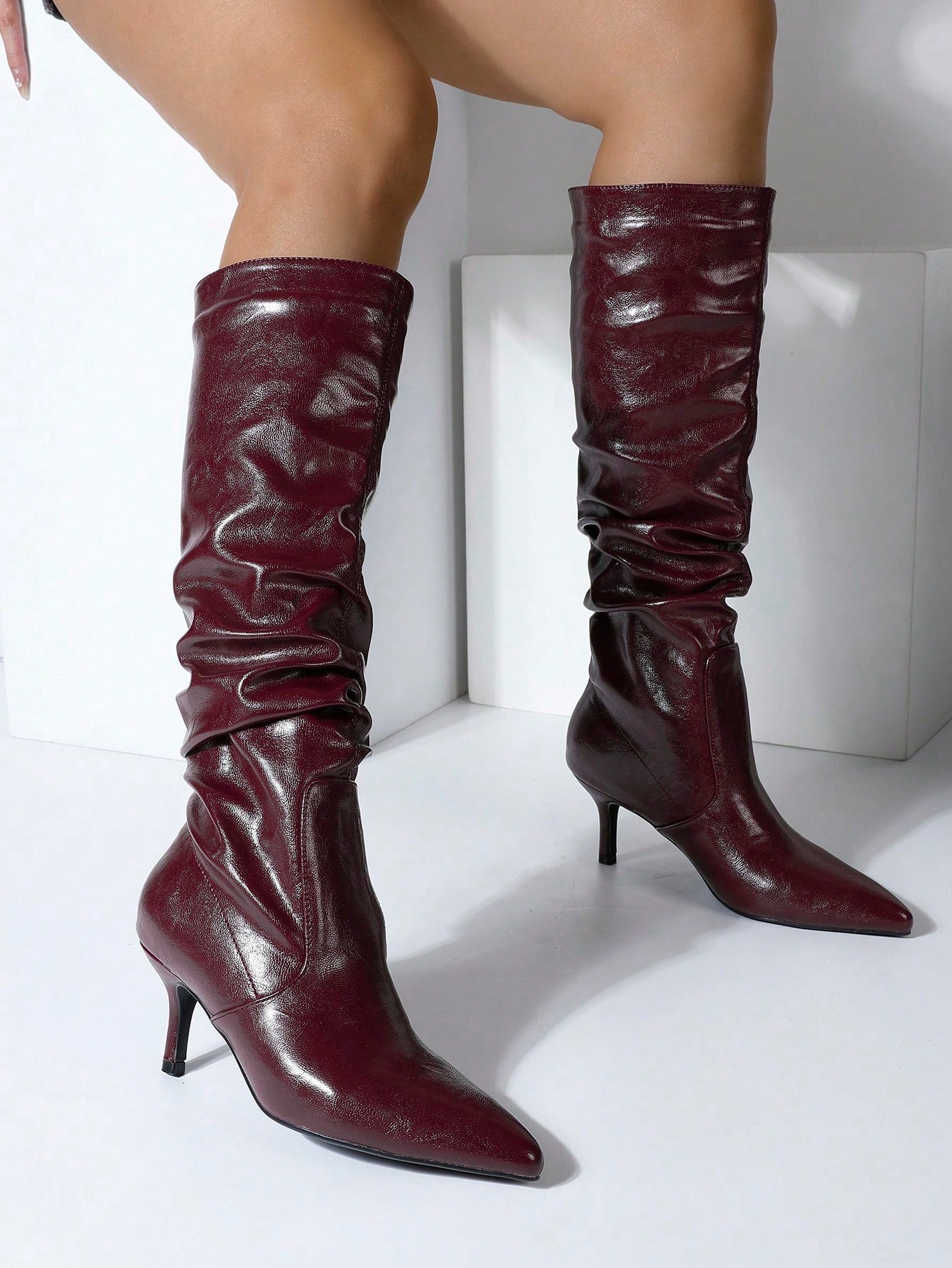 Elevate your fall and winter wardrobe with these stunning over-the-knee boots that scream sophistication. Crafted from luxurious crinkled suede and leather, they deliver that perfect blend of texture and elegance in timeless black. The sleek high heel adds instant glamour to any outfit—whether you're dressing up for a night out or making a statement during your daily adventures. These boots hug your leg beautifully and pair effortlessly with everything from mini skirts to tailored trousers. Step into confid