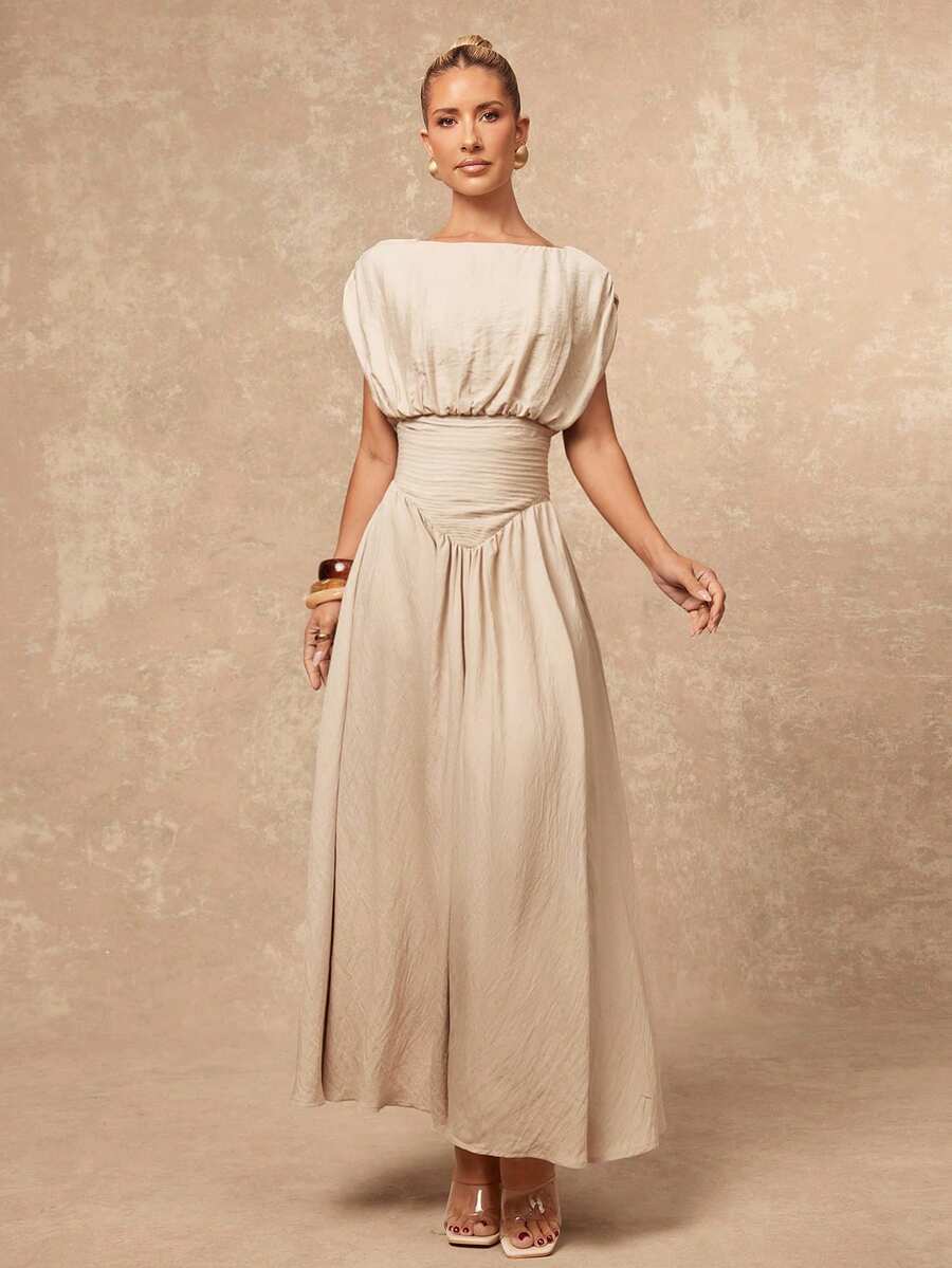 Elevate your summer wardrobe with this sophisticated oversized boat neck dress. Crafted from a luxurious viscose-polyamide blend, this A-line silhouette features elegant ruching details and a flattering high waist that creates a graceful, flowing shape. The sleeveless batwing design and lined construction offer both comfort and style, making it an ideal choice for vacations, evening events, and special celebrations. Available in a versatile khaki tone, this dress transitions effortlessly from day to night. 