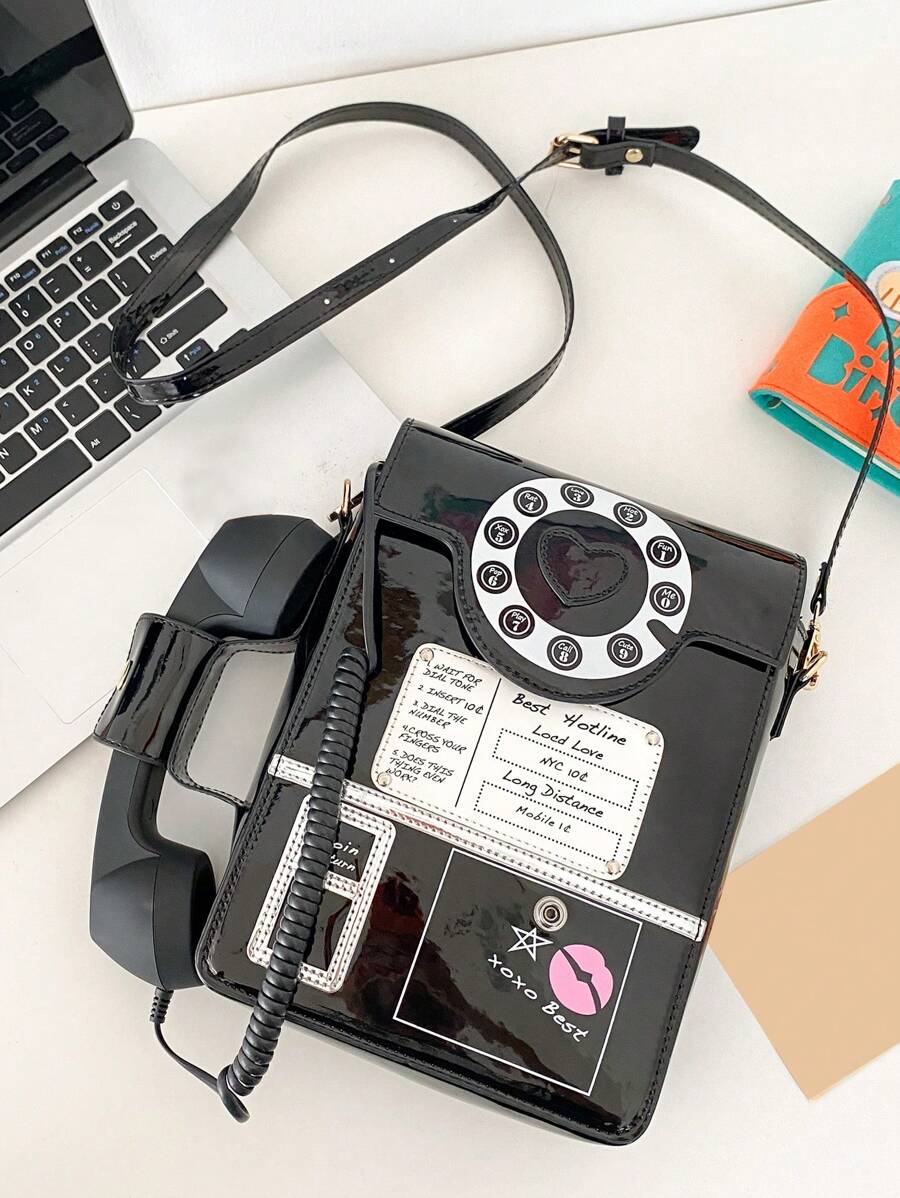 Add a playful twist to your look with this chic patent leather crossbody bag, designed in a quirky telephone-inspired shape. Its asymmetric silhouette adds a fun edge while keeping your essentials close and stylish. Perfect for those who love to stand out with a unique accessory that’s both practical and eye-catching.