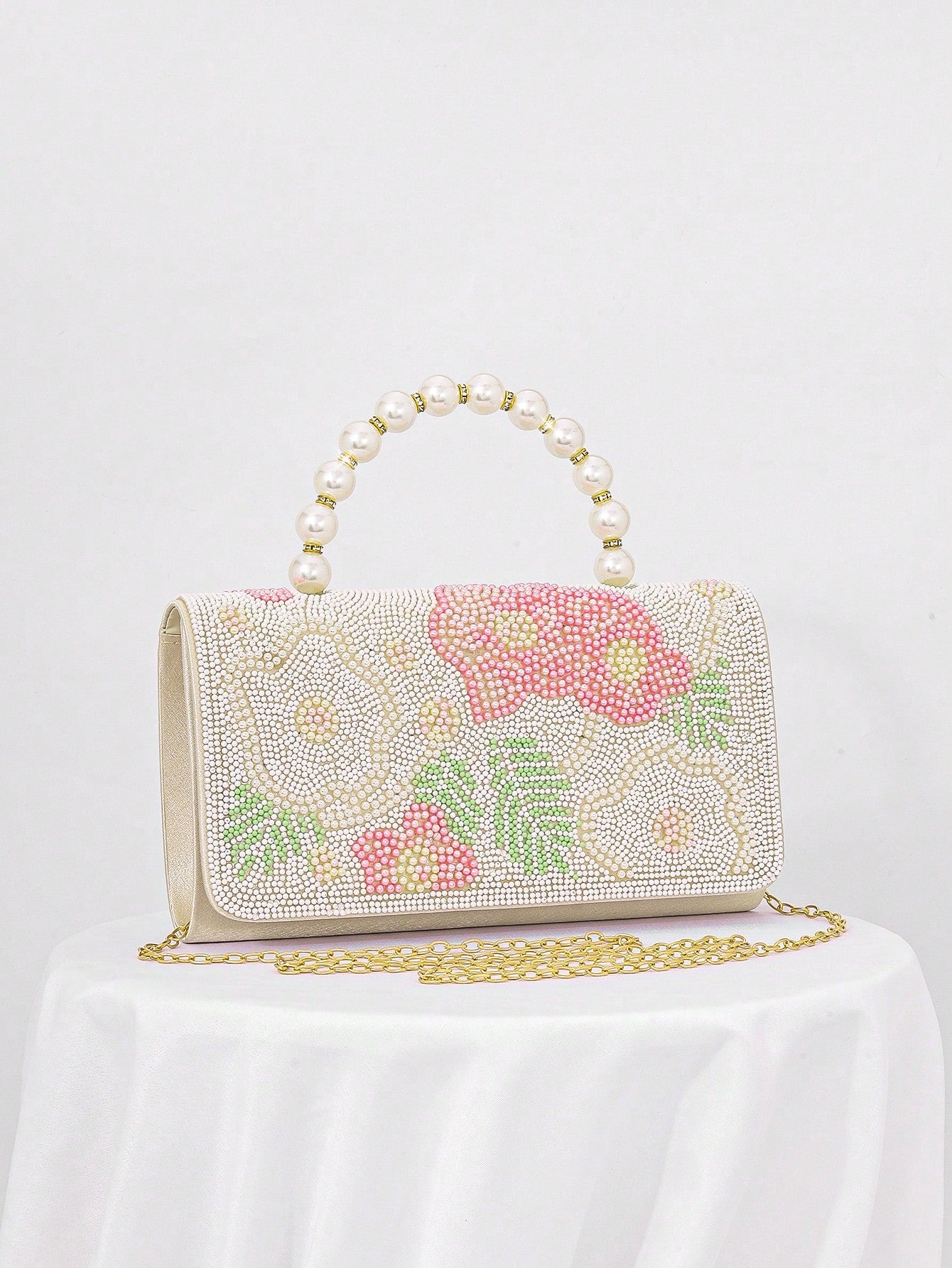 Add a touch of whimsy to your evening look with this Chic Pearl Flower Print Evening Clutch. Its delicate pearl flower design brings a playful charm while keeping things elegant, perfect for turning heads at formal events and celebrations. Compact yet roomy enough for your essentials, this clutch is your new go-to for stylish nights out.