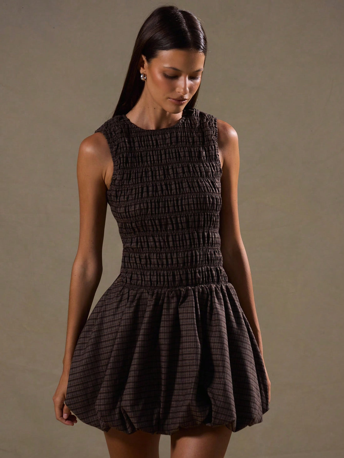 Step into style with the Chic Plaid Ruched Puffball Dress, a playful take on classic elegance. This sleeveless sundress features a charming ruched bodice and a voluminous puffball skirt that dances with every step. Perfect for layering or wearing solo, it brings a fresh twist to your wardrobe year-round. Whether it’s a sunny day or layered for cooler nights, this dress promises fun, flirty fashion with a dash of timeless plaid flair.