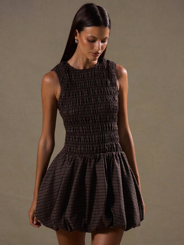 Step into style with the Chic Plaid Ruched Puffball Dress, a playful take on classic elegance. This sleeveless sundress features a charming ruched bodice and a voluminous puffball skirt that dances with every step. Perfect for layering or wearing solo, it brings a fresh twist to your wardrobe year-round. Whether it’s a sunny day or layered for cooler nights, this dress promises fun, flirty fashion with a dash of timeless plaid flair.