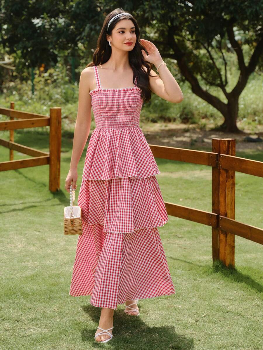 Get ready to turn heads in this Chic Plaid Summer Dress! The elegant red and white design features a fitted strap cake dress that will flatter your figure. Perfect for any summer occasion, this dress will make you feel confident and stylish. Don't miss out on this must-have addition to your wardrobe!