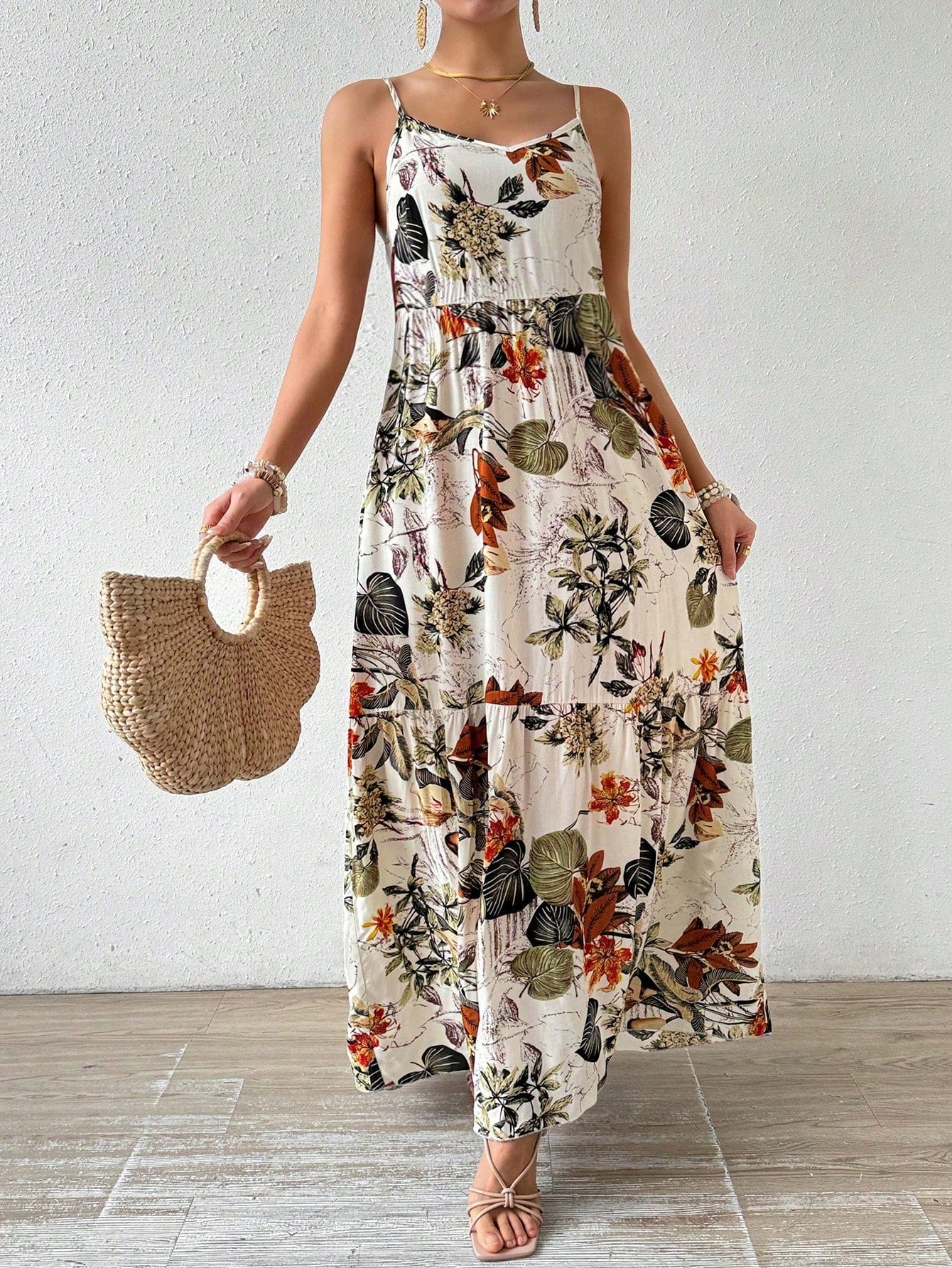 This dress has got you covered for all your holiday outings! The chic plant print and ruffle hem give it a playful touch, while the spaghetti straps add a flirty appeal. Perfect for any occasion, you'll be turning heads wherever you go. Get ready to slay in this maxi dress!