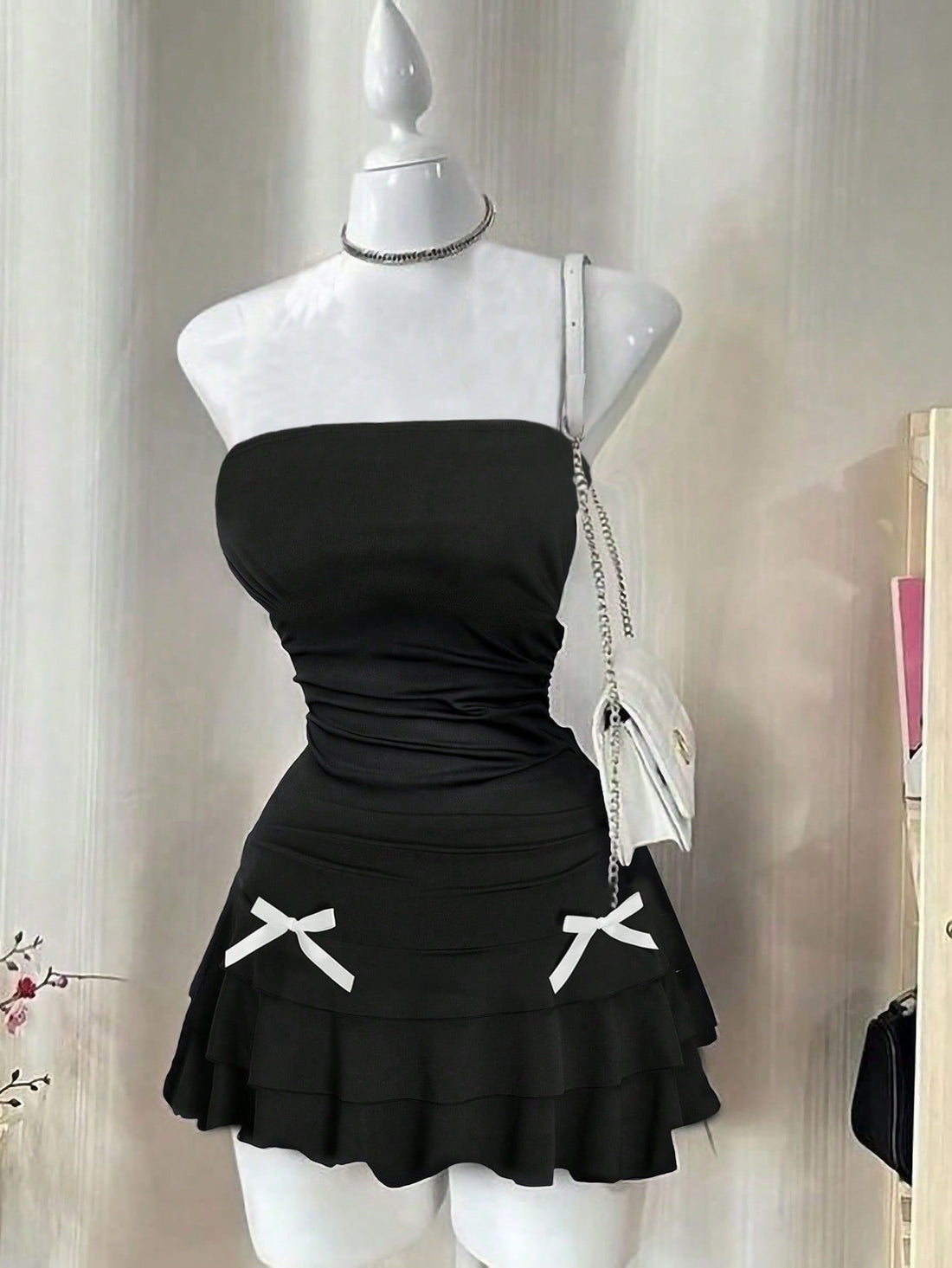 Stay chic and stylish with our Plus-Size Strapless Pleated Bow Tie Dress in elegant black. Perfect for any occasion, this short dress features flattering pleats and a playful bow tie. Upgrade your wardrobe with this must-have dress! (No other dress will do!)