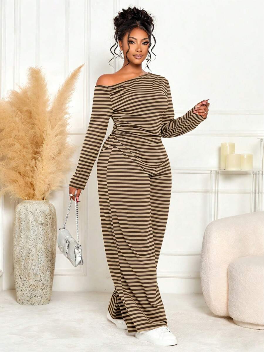 Elevate your seasonal wardrobe with this sophisticated two-piece set designed for confident style. The asymmetric striped top features modern lines and flattering proportions, while the high-waist wide-leg pants create an elongated silhouette that flatters every frame. The coordinated pairing makes dressing effortless—wear together for polished occasions or mix and match with your existing pieces. Crafted for comfort and movement, this set transitions seamlessly from casual outings to holiday gatherings. 