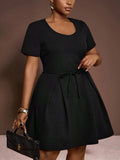 Turn heads in this chic plus size black mini A-line dress, designed to flatter your curves with a playful waist tie and graceful pleated details. Perfect for elegant occasions, it offers a fun yet sophisticated silhouette that moves with you. Dress it up or down and enjoy effortless style that's both comfortable and captivating.
