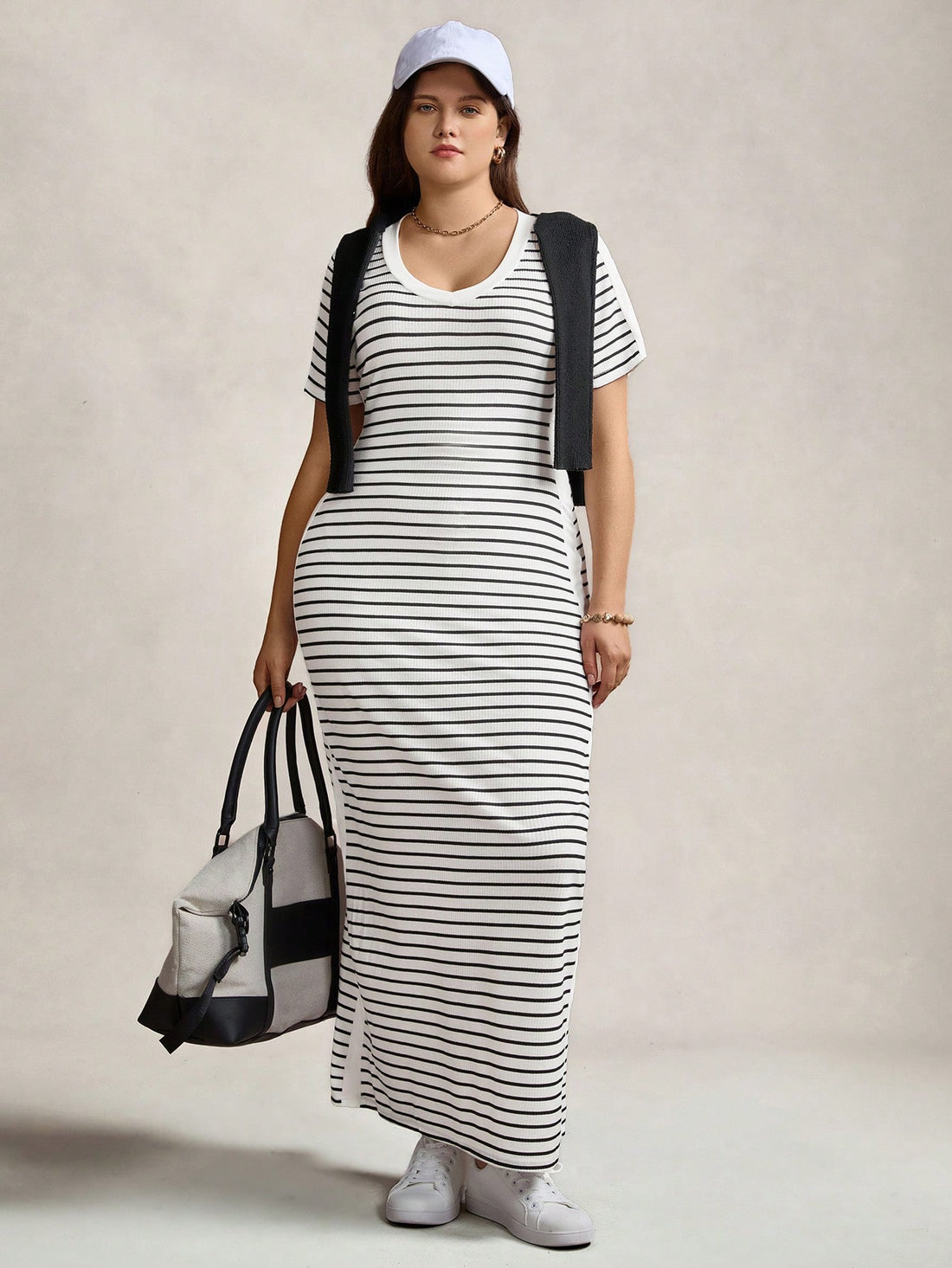 Step out in style and comfort with this playful plus size black and white striped maxi dress. Featuring a flattering V-neck and breezy short sleeves, it’s perfect for casual days or sporty adventures. The flowing design keeps you cool while the bold stripes add a fun, chic vibe to your everyday wear.