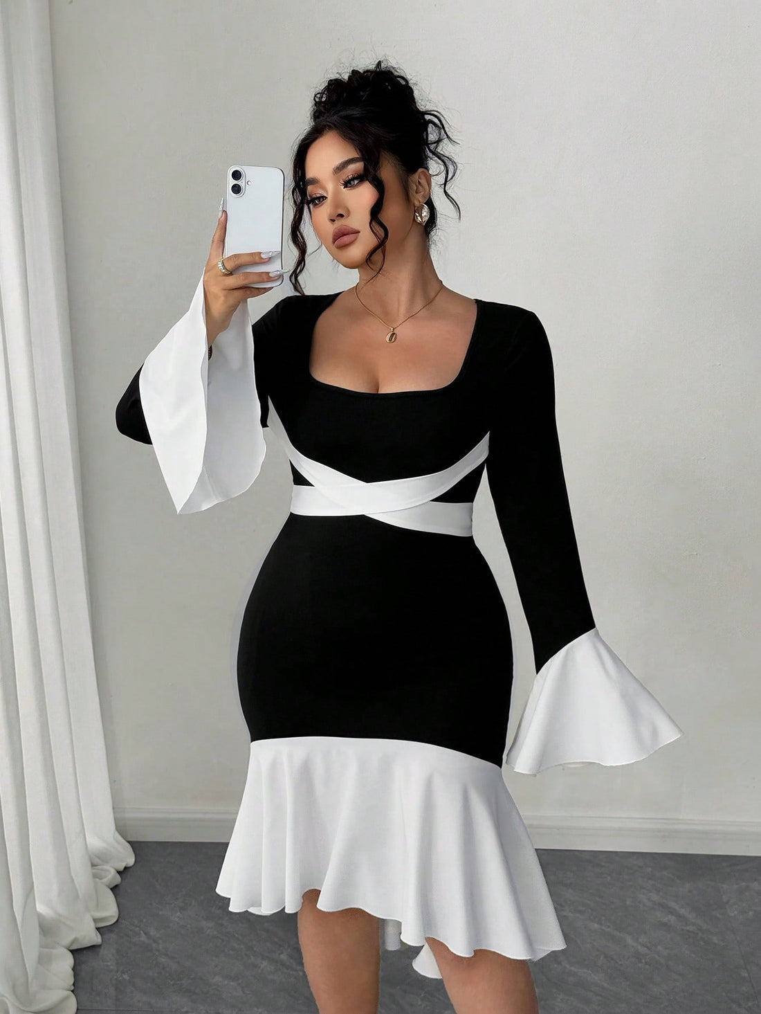Elevate your fall wardrobe with this stunning plus-size dress that's equal parts bold and beautiful. The striking contrast color blocking catches every eye, while the flattering square neckline frames your face perfectly. Bell sleeves add a touch of whimsy and movement, creating an effortlessly chic silhouette that works for brunch, date night, or anywhere you want to feel fabulous. Designed for real bodies and real style, this dress proves that fashion should always be fun and flattering.