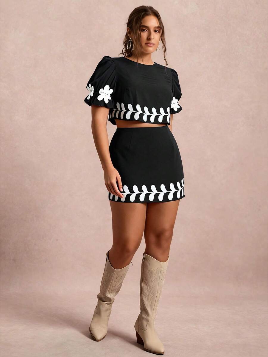 Elevate your wardrobe with this fabulous two-piece set that's equal parts fun and flirty! The puff sleeve top features a charming floral print that brings instant personality to any occasion, while the coordinating mini skirt creates a perfectly polished silhouette. Designed with plus-size curves in mind, this set offers a flattering fit that celebrates your style. Whether you're heading to holiday gatherings or keeping things casual, this dynamic duo delivers effortless charm and confidence. Mix, match, or