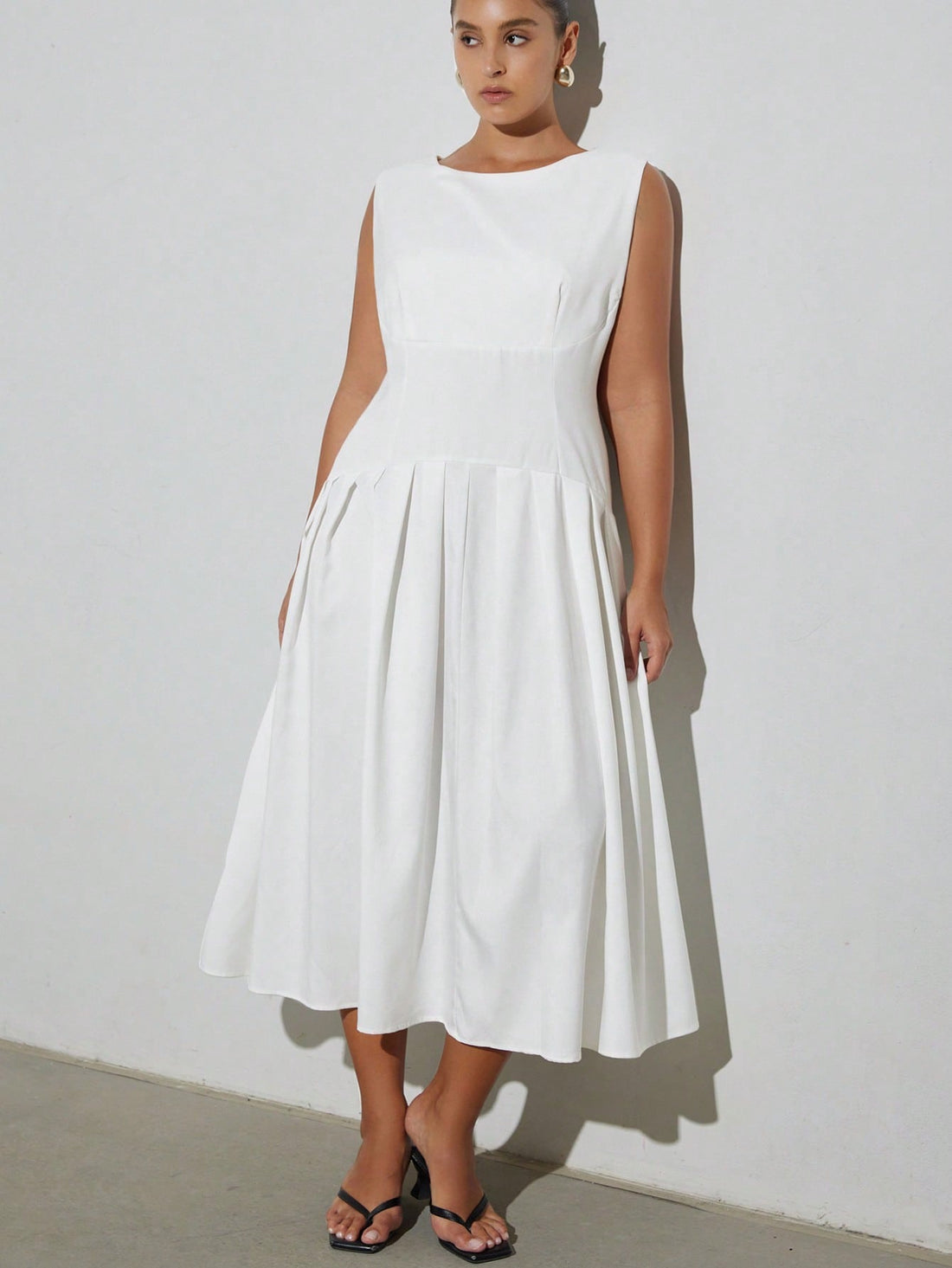 Turn heads effortlessly in this chic plus size white sleeveless dress, featuring a stylish one-shoulder hem that adds a flirty twist. The pleated patchwork detail brings texture and movement, making every step feel like a dance. Perfect for sunny days or evening fun, this dress combines comfort with playful elegance.
