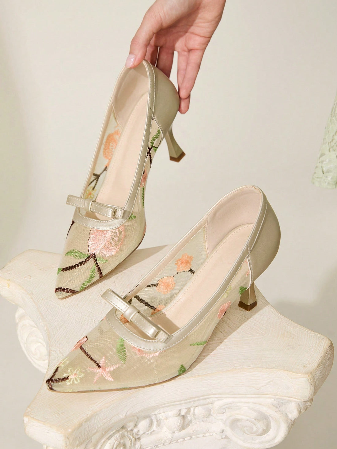 Step out in style with these chic beige stiletto pumps featuring a pointed toe and delicate embroidered mesh. The playful bow detail adds a flirty touch, making them perfect for turning heads at any event. Elevate your look with elegance and a hint of fun!