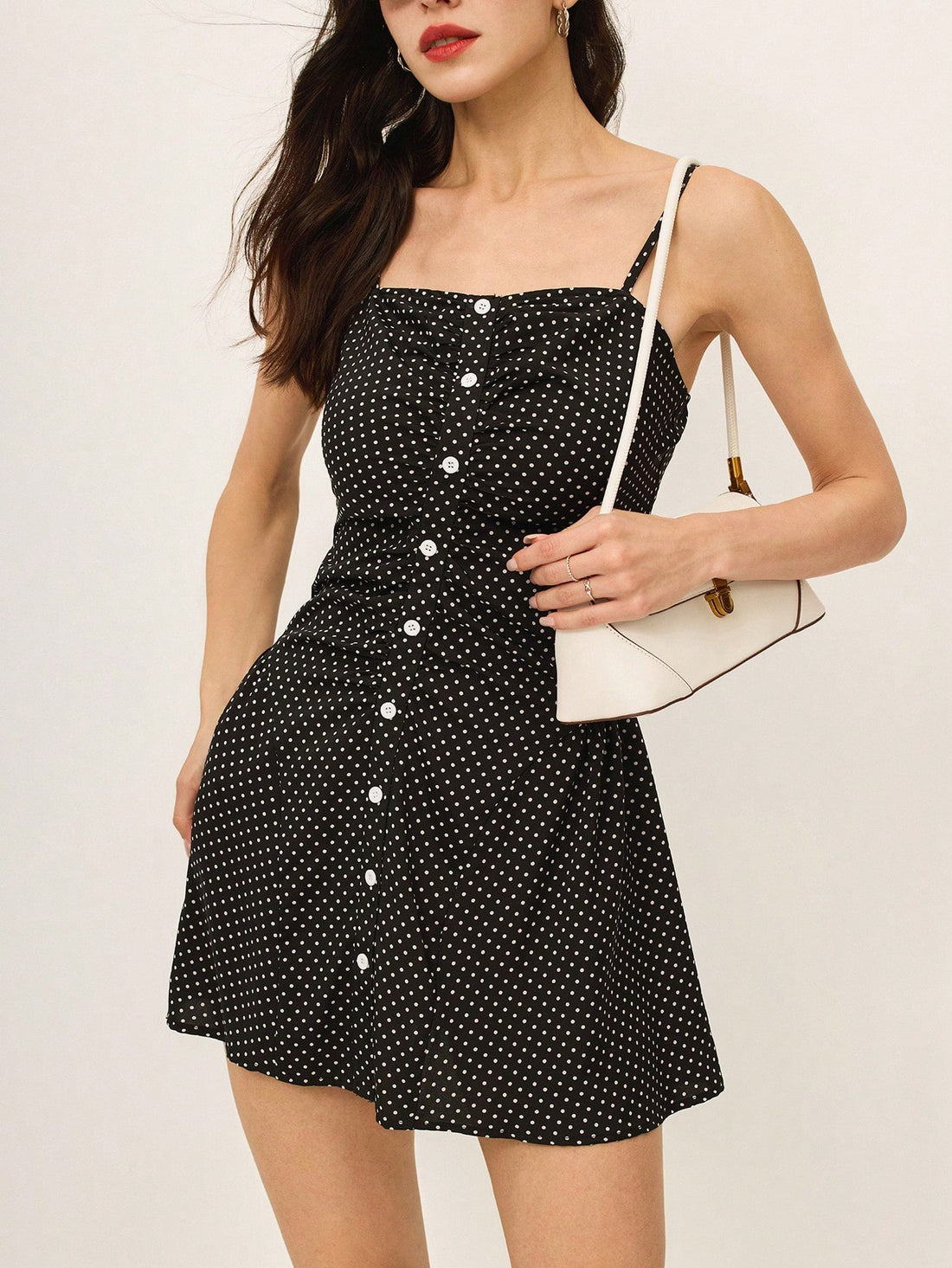 Unleash your playful side with our Chic Polka Dot Camisole Mini Dress by Po-selle! Featuring a fun polka dot print, adjustable straps, and cute front buttons, this dress is perfect for any occasion. Stay stylish and chic with Po-selle!