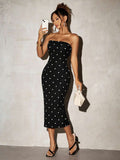 Full-body front view of black strapless polka dot bodycon midi dress