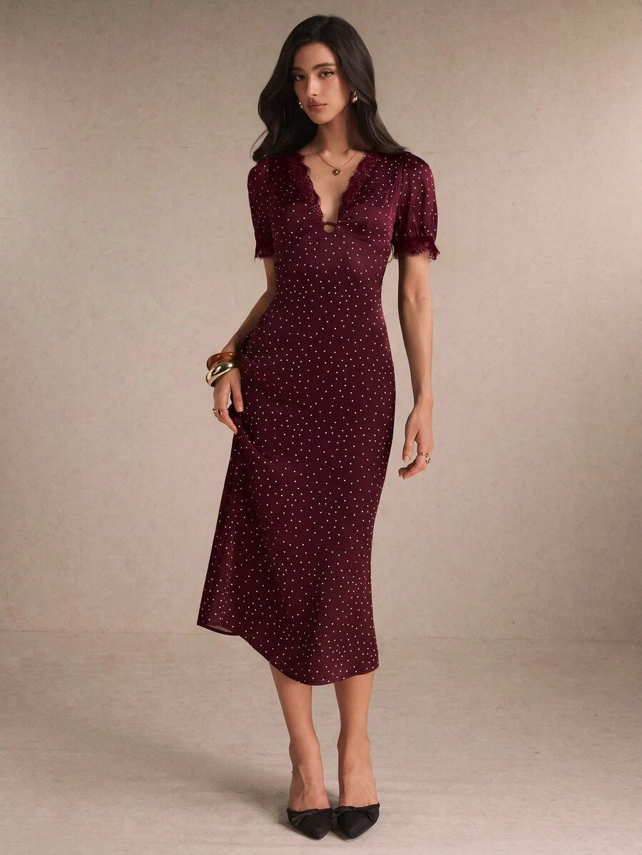 Front view burgundy polka-dot midi dress with lace V-neck and puff sleeves